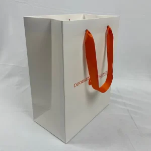 Customizable White Matte Paper Bags with Vibrant Orange Logo for Fashion & Gift Packaging