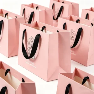 OEM Custom Luxury Printed Pink Paper Shopping Bag with Ribbon Handle for Cosmetic & Fragrance Brand Packaging Solutions