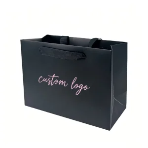 Sleek Matte Black Carry Tote Bags Black Ribbon Handles Custom Pink Handwritten Font Brand Logo Print for Cosmetic Packaging